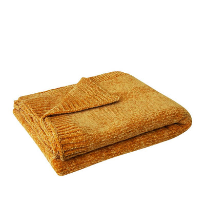 soft chenille throw in yellow gold colour folded & kept on white bench top.